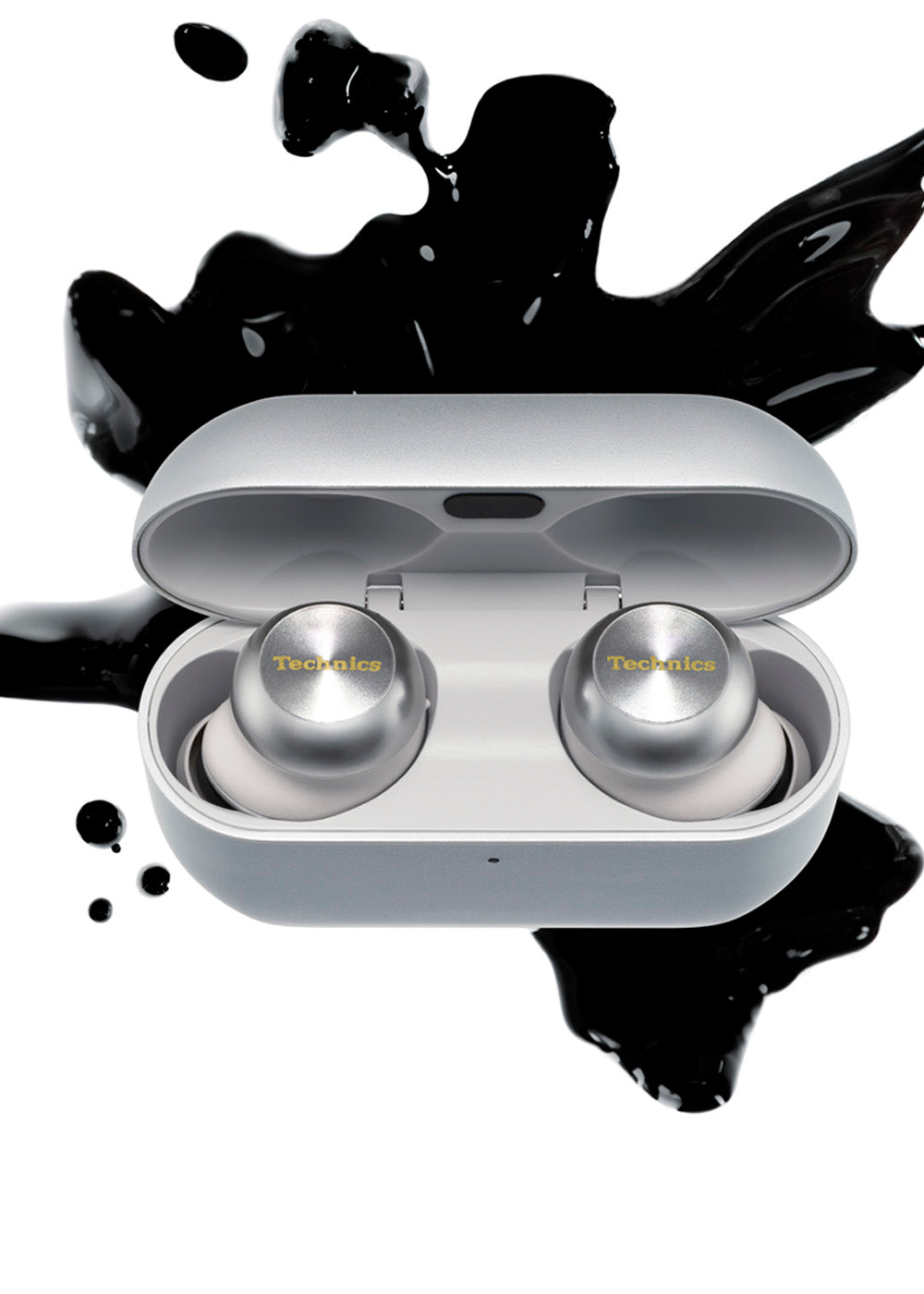 Technics silver AZ100 earbud headphones in charging case with black ink splatter in the background