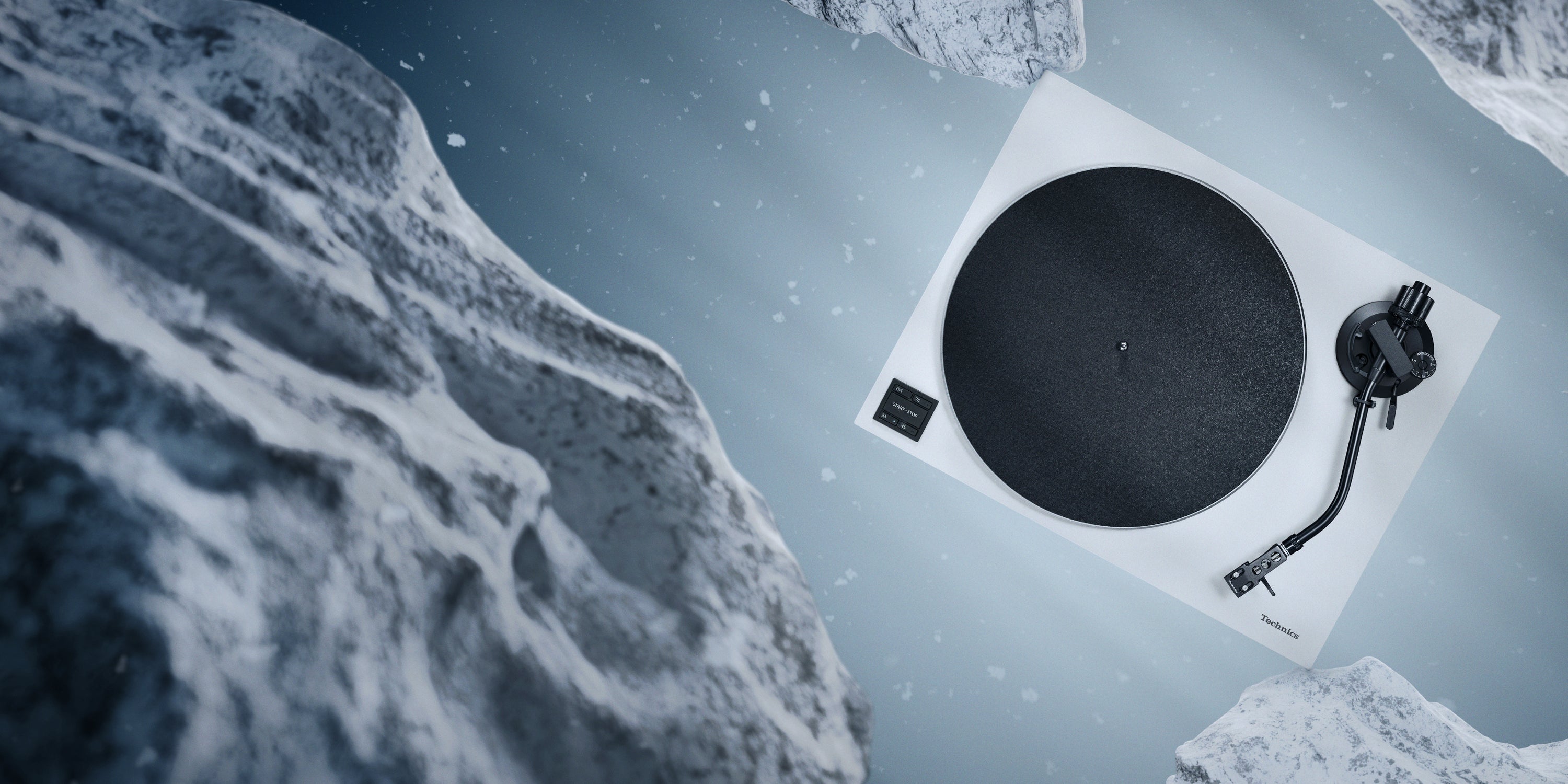 Turntable on a snowy landscape with a mountainous background